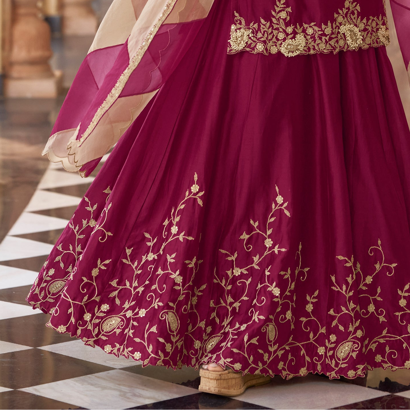 Embroidery pattern detail on wine kameez front