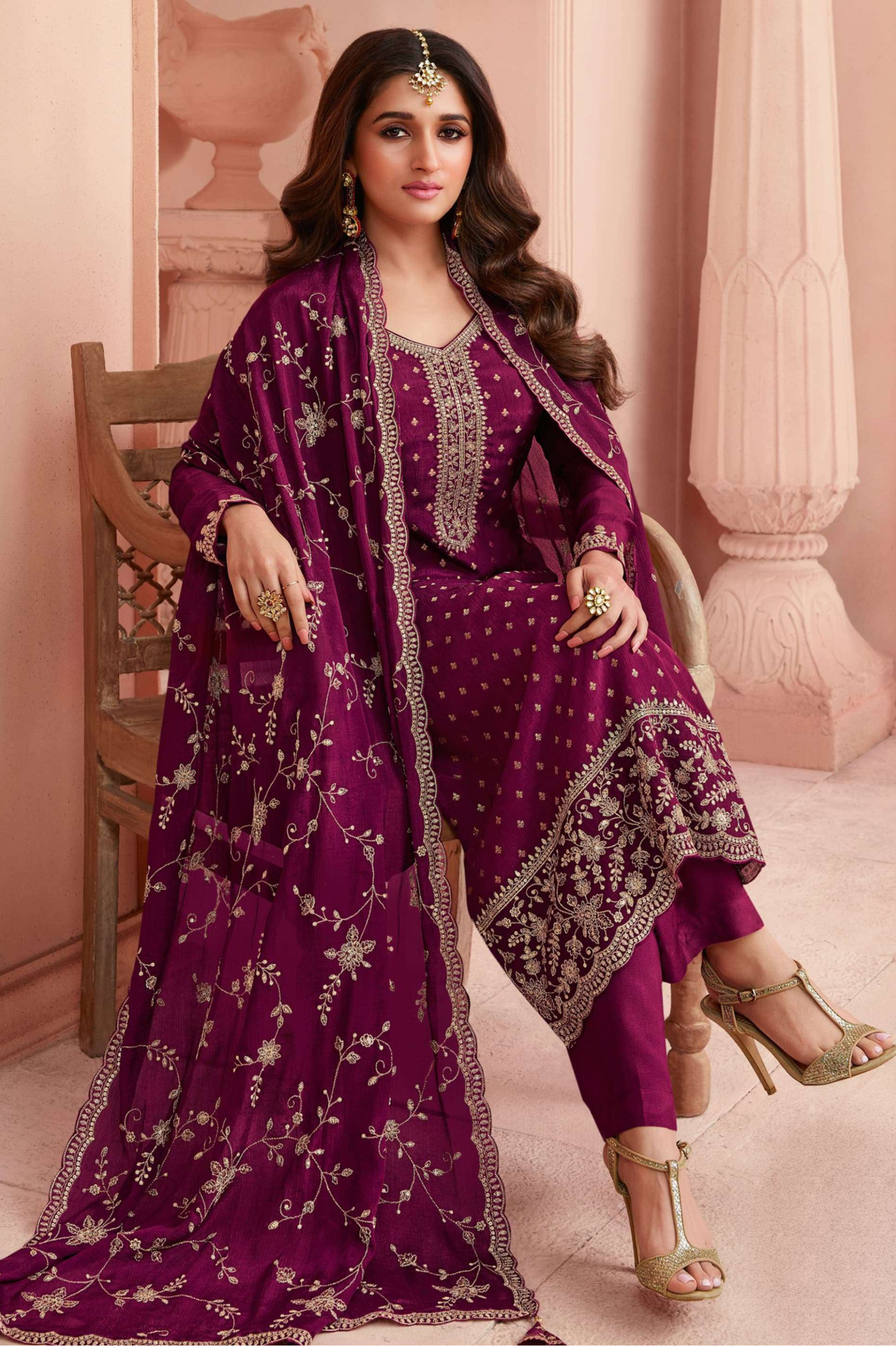 Close-up embroidery detail on wine kameez fabric