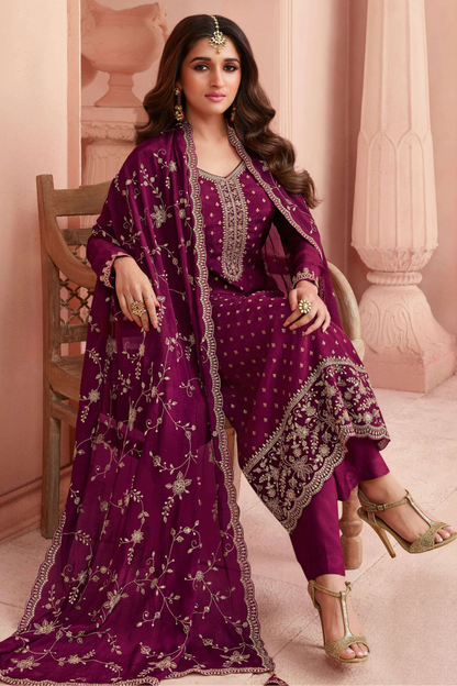 Close-up embroidery detail on wine kameez fabric