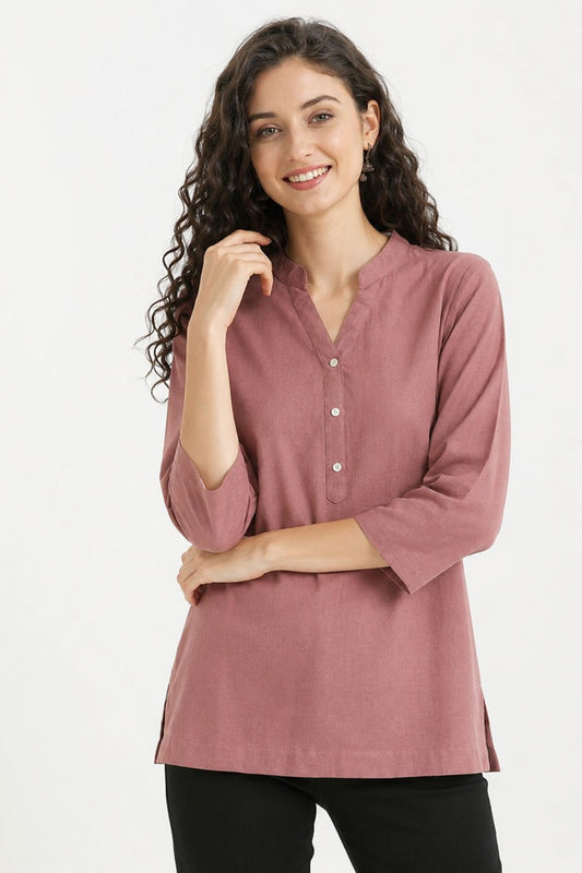 Model wearing rose gold tunic with button neckline