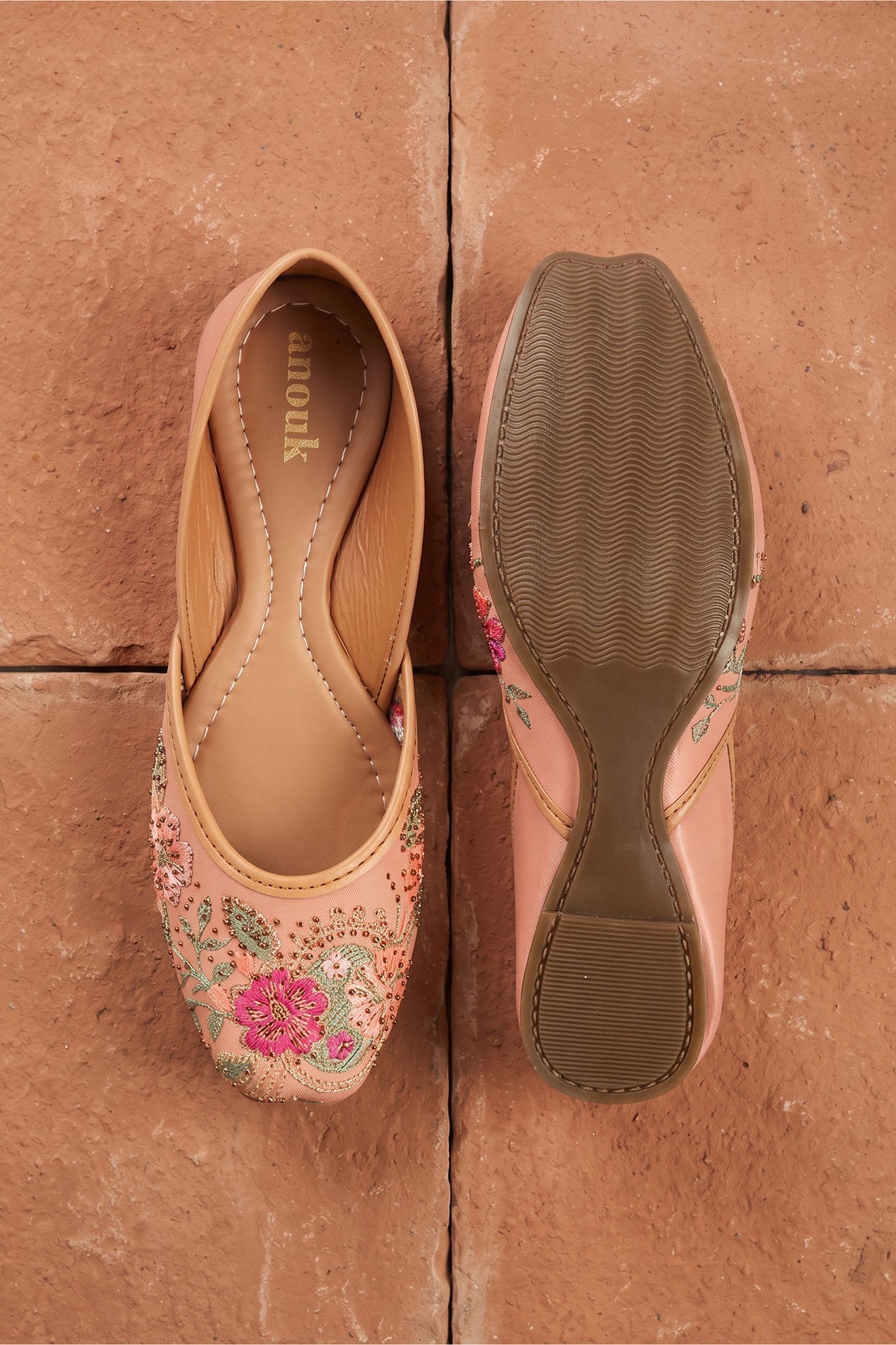Top view of women's traditional mojarras flats in peach