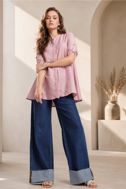 Model wearing dusty rose pink Womens Tunic Tops with wide leg denim