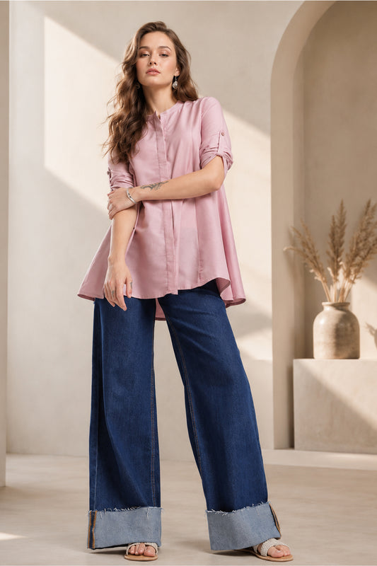 Model wearing dusty rose pink Womens Tunic Tops with wide leg denim