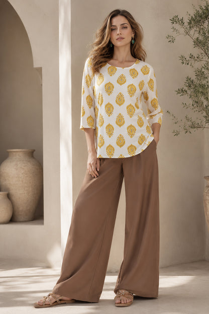 Woman wearing white ethnic motif printed tunic with wide leg pants