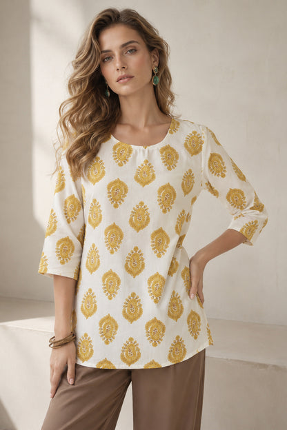 White casual tunic paired with flowy wide leg pants