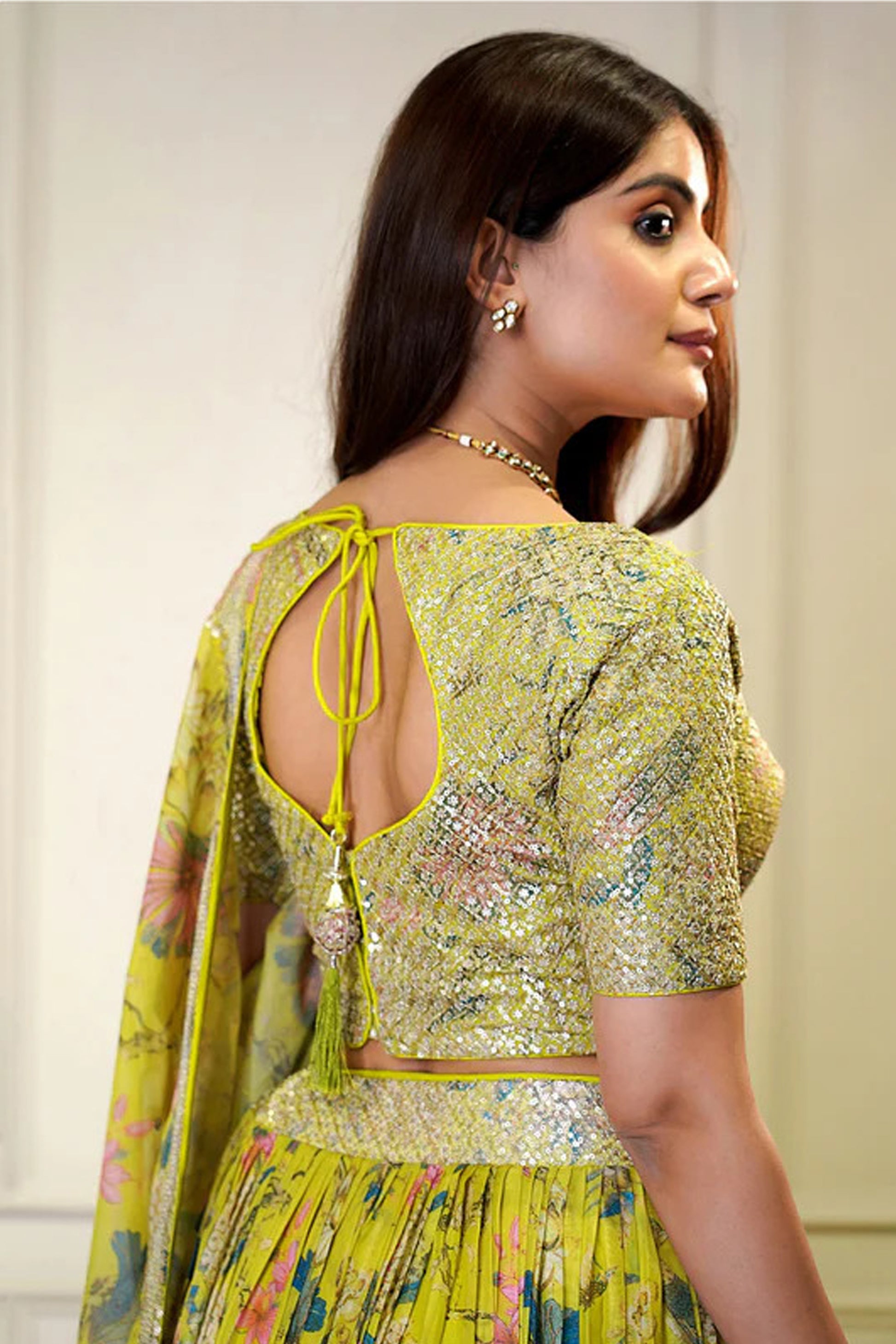 Back view of yellow lehenga choli in organza fabric