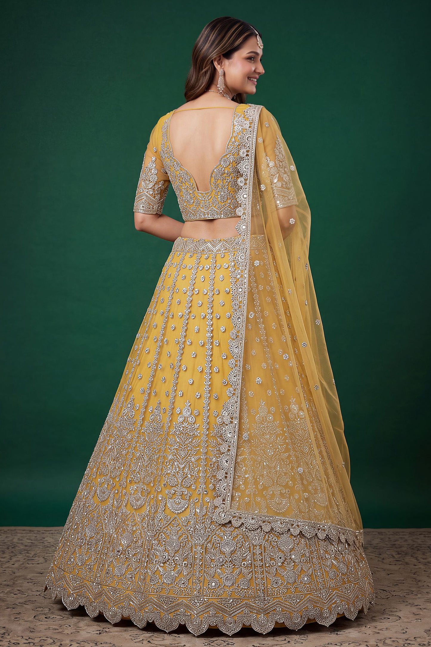Back view of yellow lehengha choli with embroidered detailing