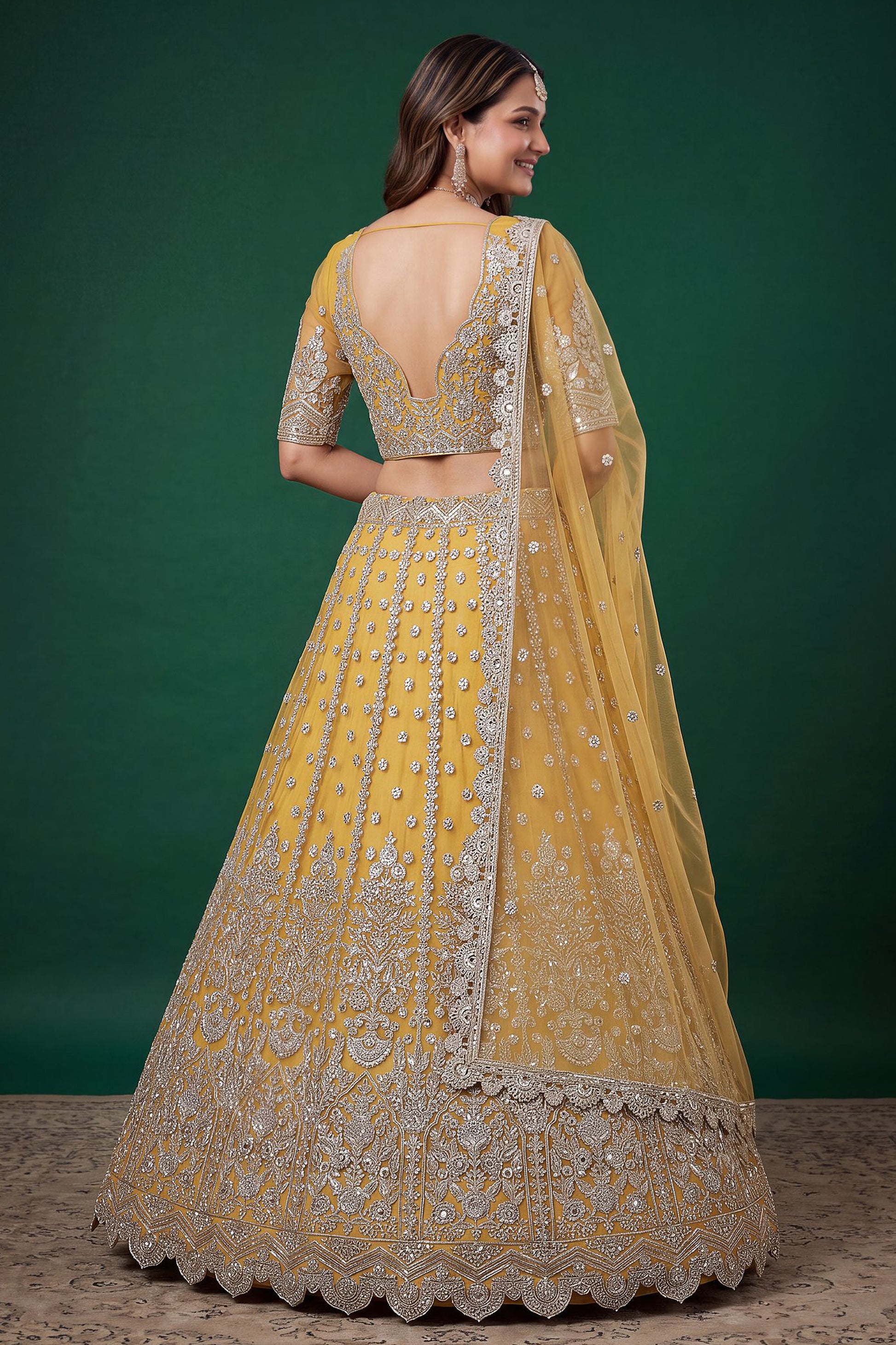 Back view of yellow lehengha choli with embroidered detailing