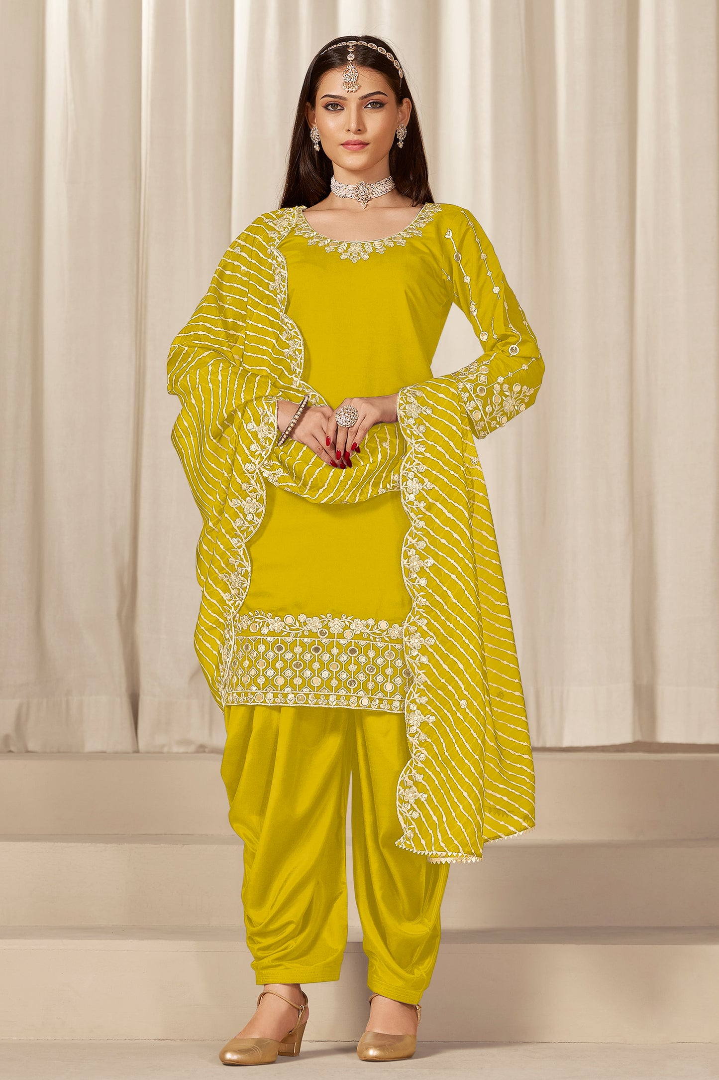 Front view of yellow patiyala suit with embroidery and mirror work