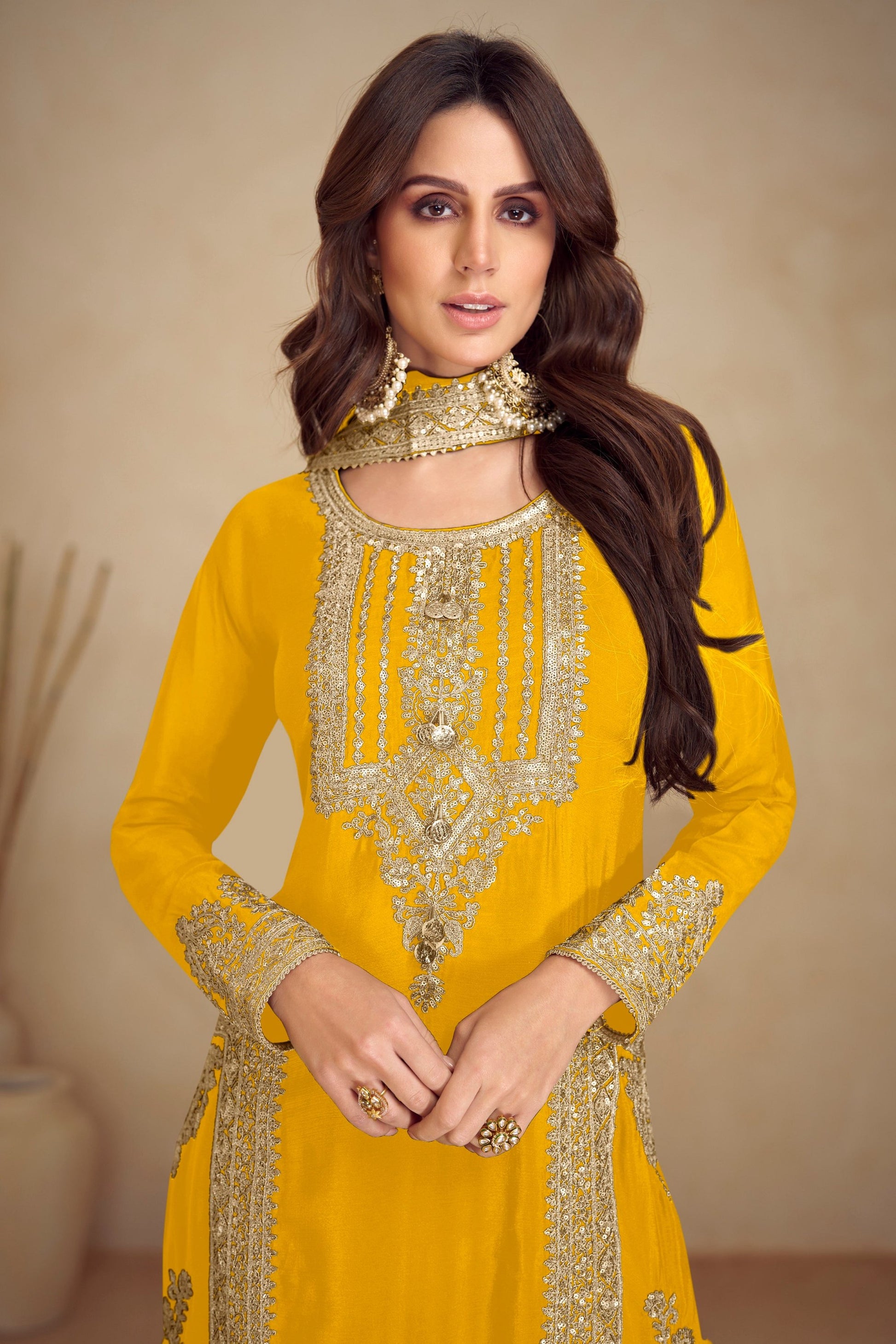 Close up of embroidery work on yellow salwar kameez

