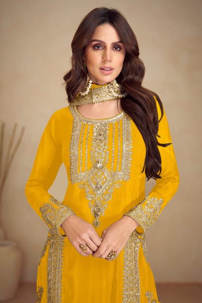 Close up of embroidery work on yellow salwar kameez
