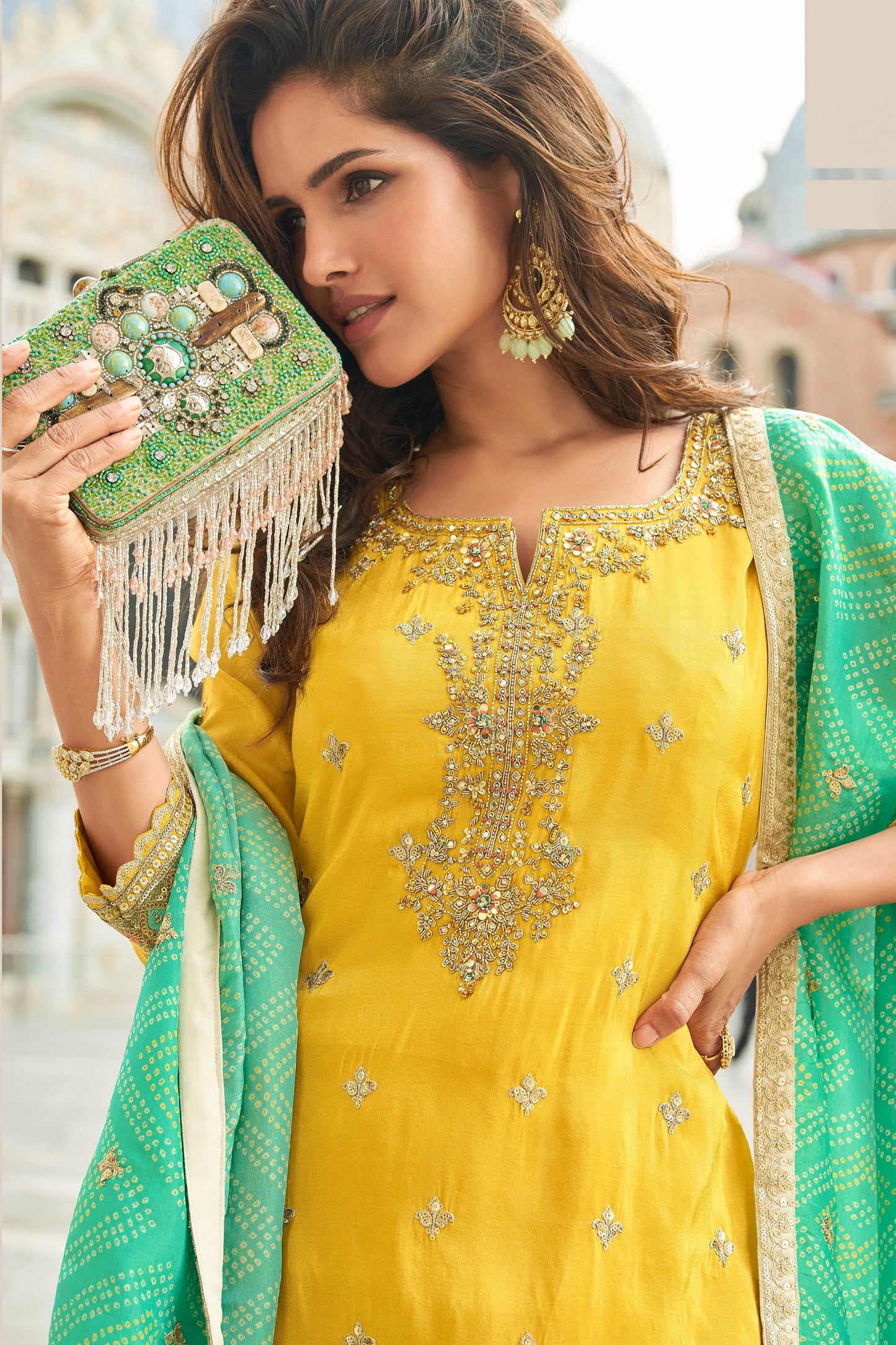 Embroidery detail on yellow kameez fabric close up