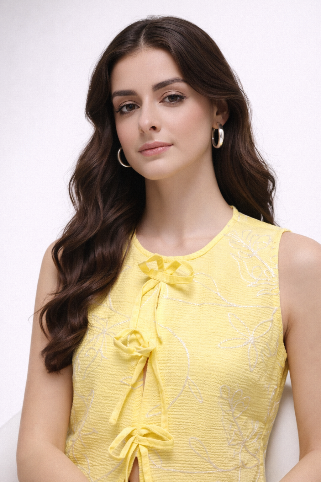 detail shot of floral threadwork on yellow top