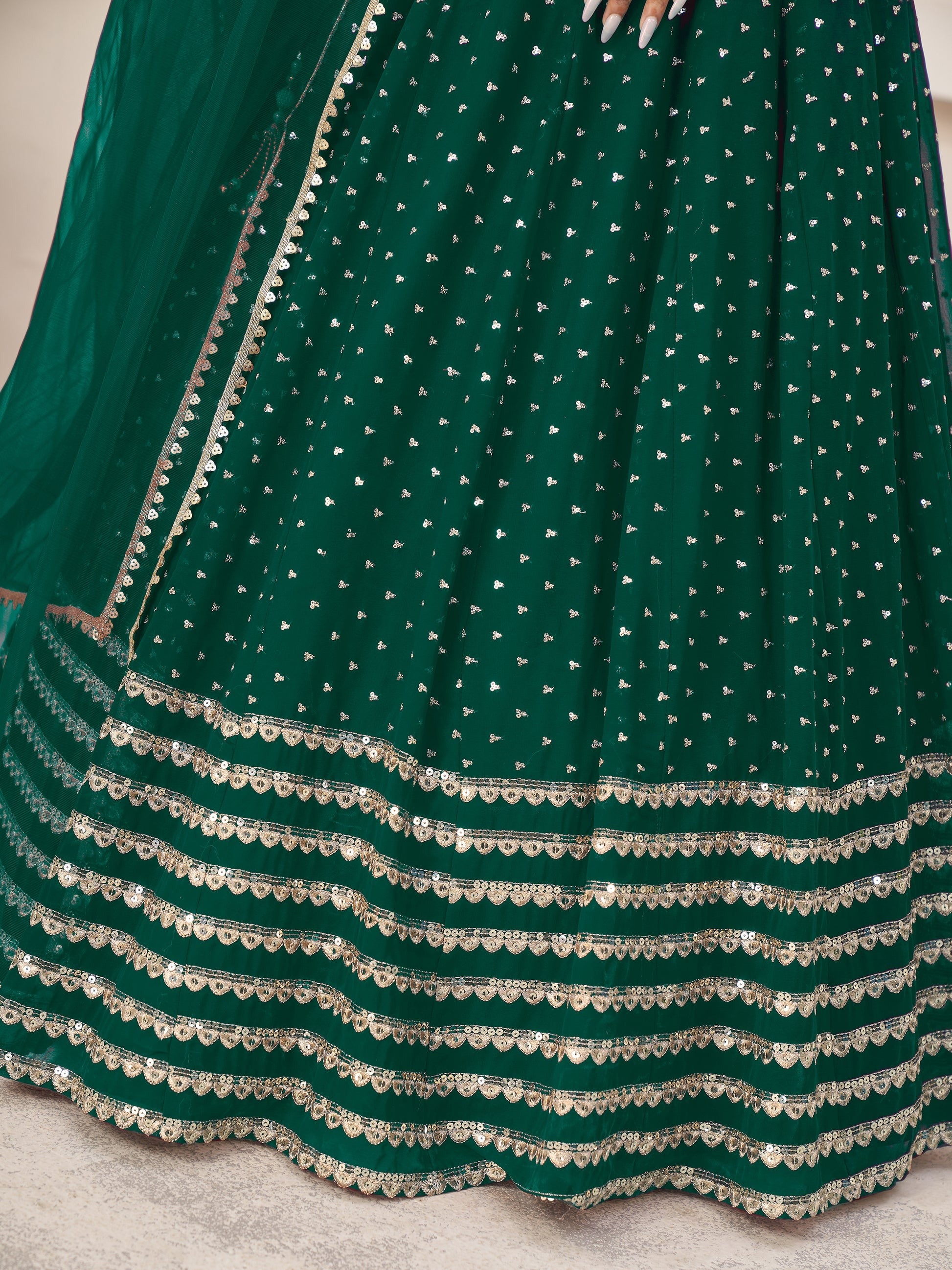 Detailed craftsmanship of sequins and zari work