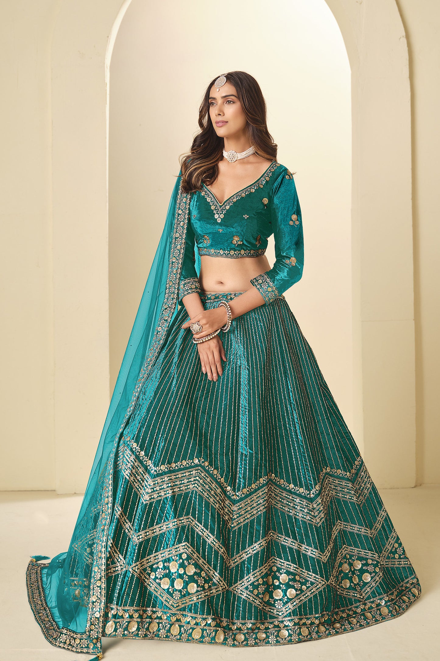 Model wearing Teal Green Lehenga Choli with sequins work