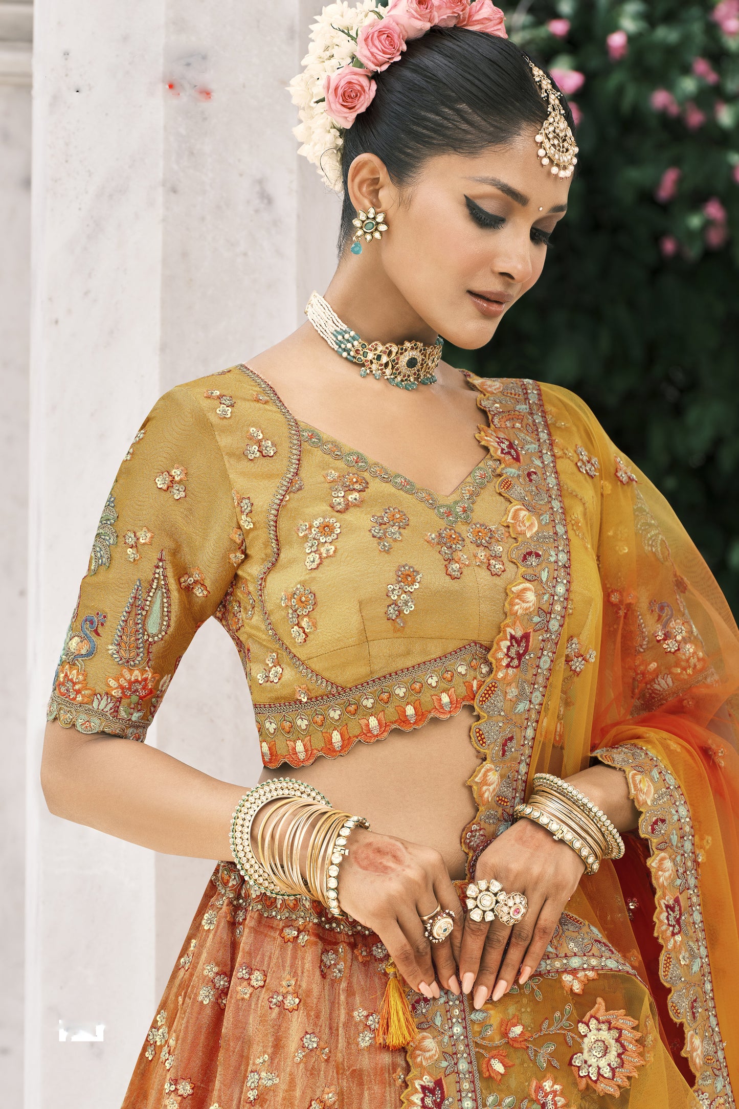 Orange lehenga hemline embroidery close-up