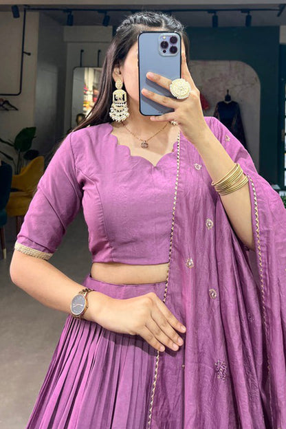 Close-up of zari weaving detail on purple lehenga